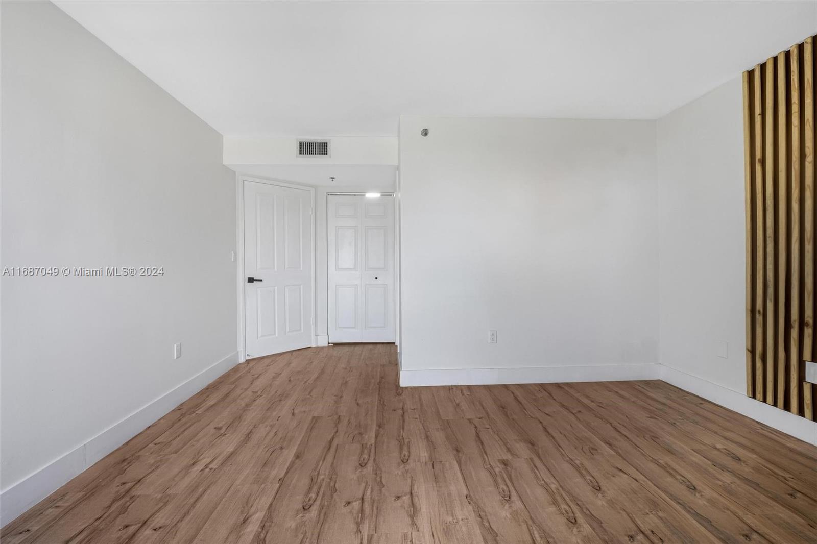 2351 Douglas Road, Unit 504 Miami, FL 33145 - Photo 20 of 41 a view of a room with wooden floor and white walls
