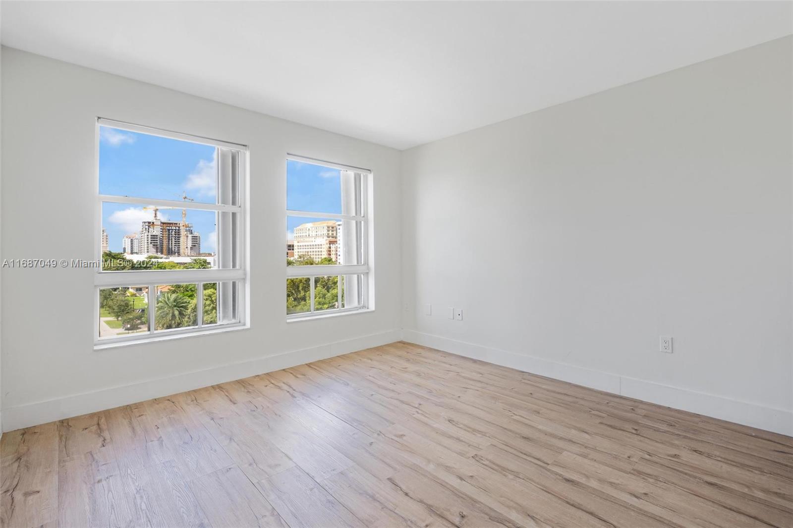 2351 Douglas Road, Unit 504 Miami, FL 33145 - Photo 22 of 41 a view of an empty room with wooden floor and a window