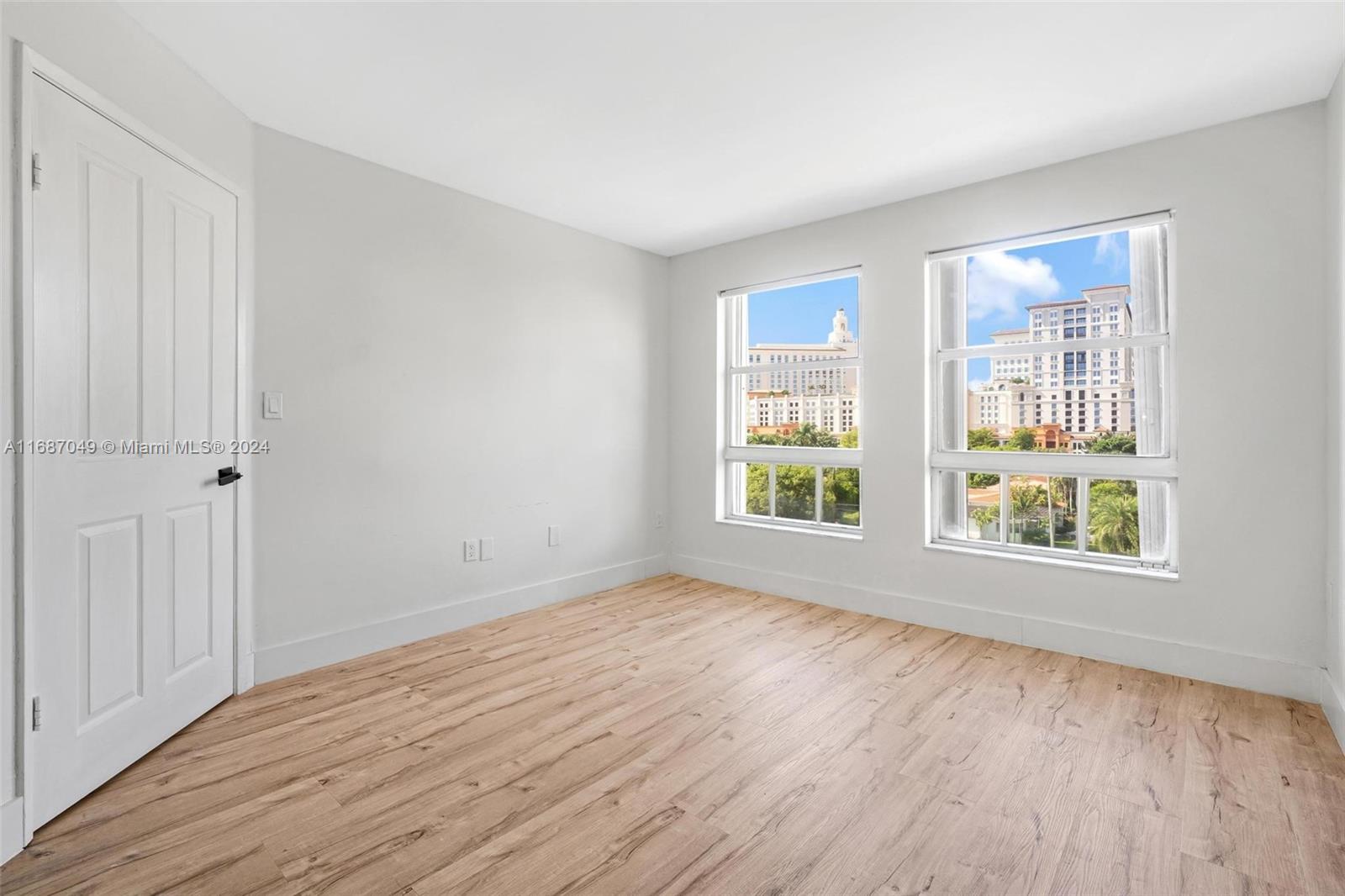 2351 Douglas Road, Unit 504 Miami, FL 33145 - Photo 24 of 41 a view of an empty room with wooden floor and a window