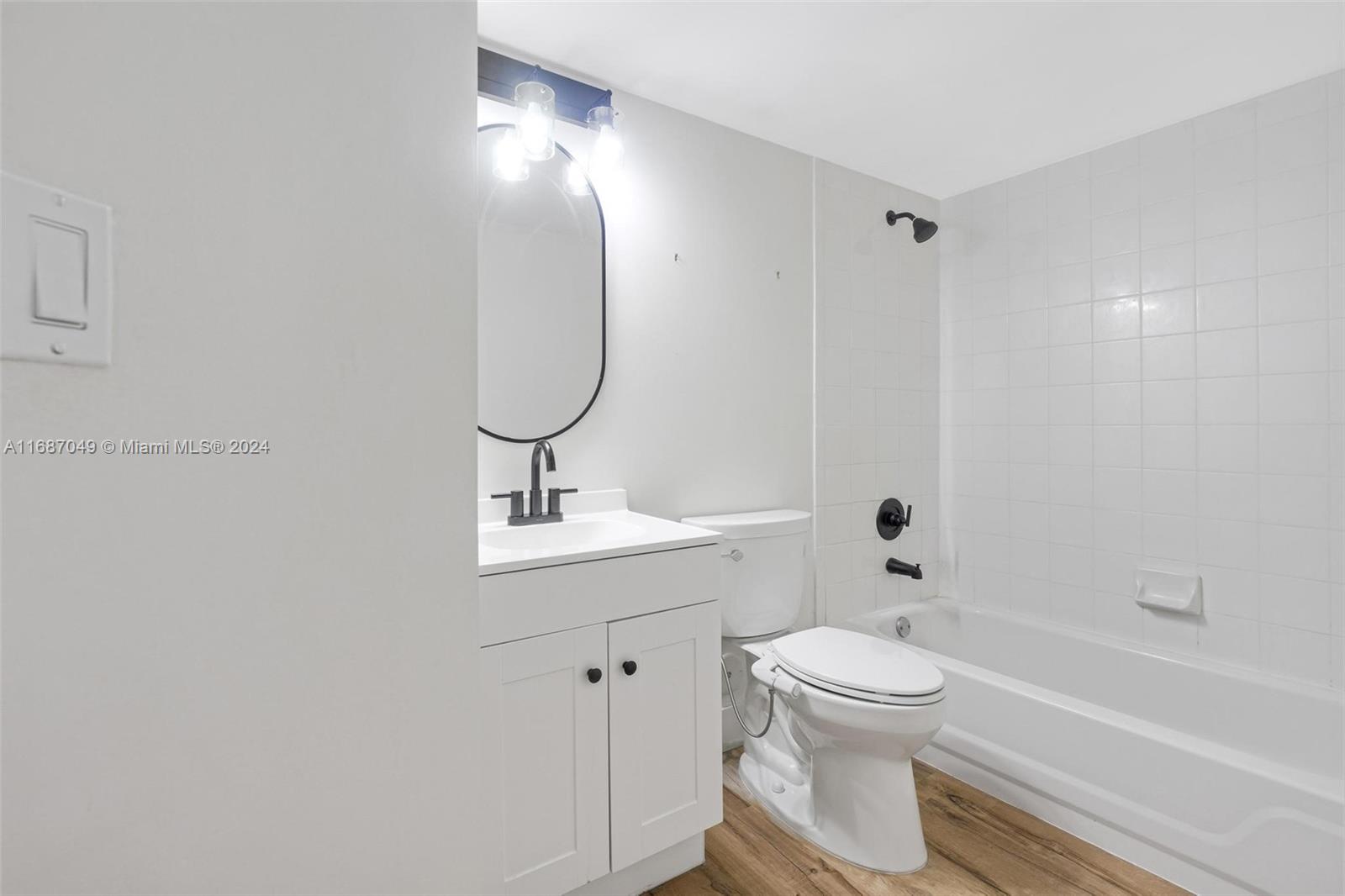 2351 Douglas Road, Unit 504 Miami, FL 33145 - Photo 28 of 41 a bathroom with a toilet sink and a mirror