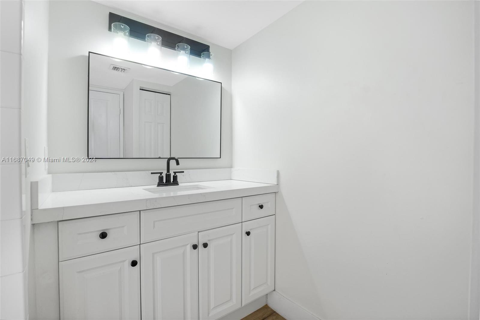2351 Douglas Road, Unit 504 Miami, FL 33145 - Photo 29 of 41 a bathroom with a sink and mirror