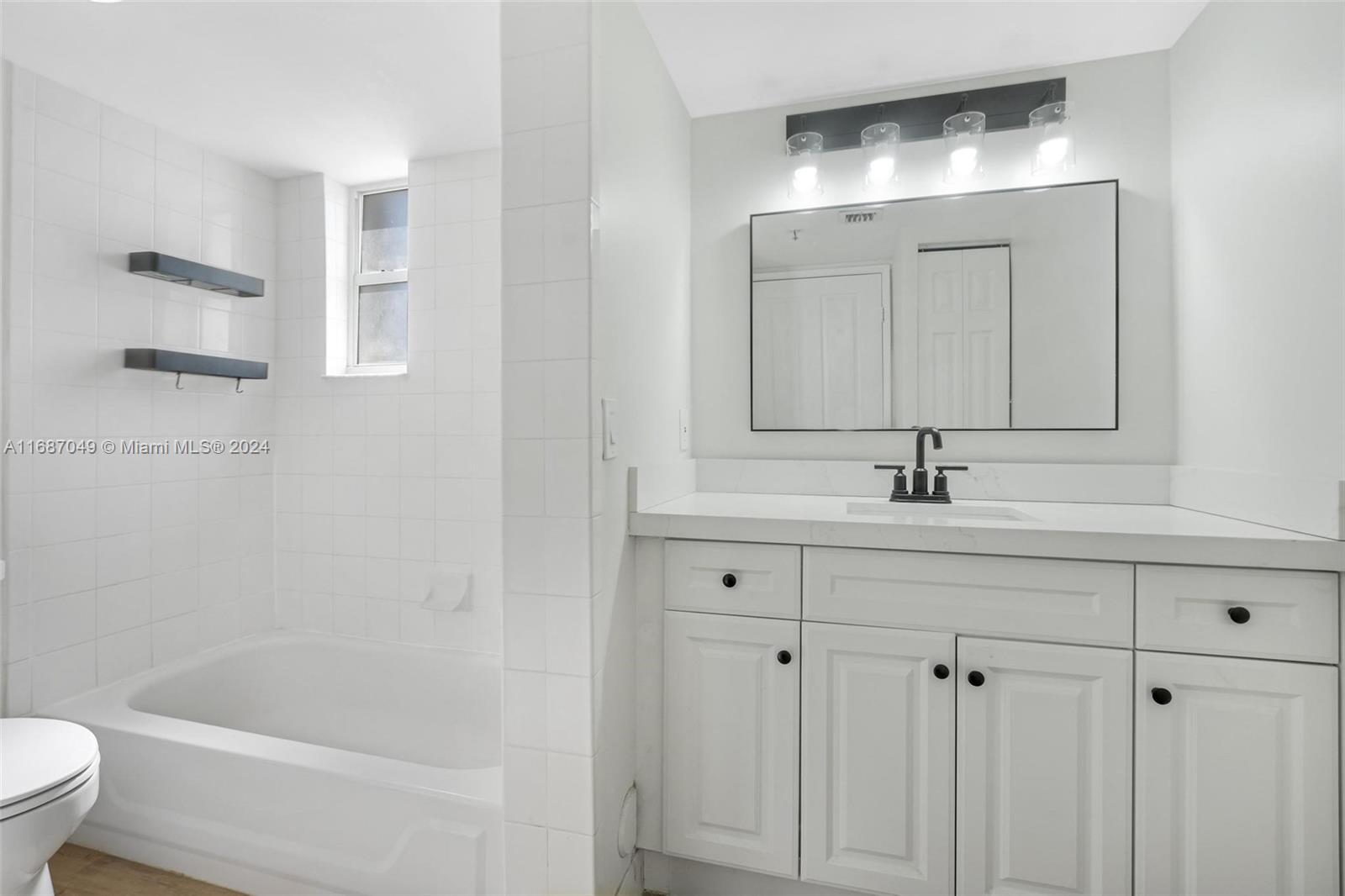 2351 Douglas Road, Unit 504 Miami, FL 33145 - Photo 30 of 41 a bathroom with a sink a toilet and bathtub