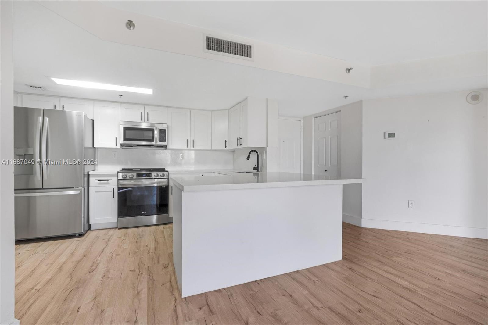 2351 Douglas Road, Unit 504 Miami, FL 33145 - Photo 6 of 41 a kitchen with stainless steel appliances a refrigerator sink and stove