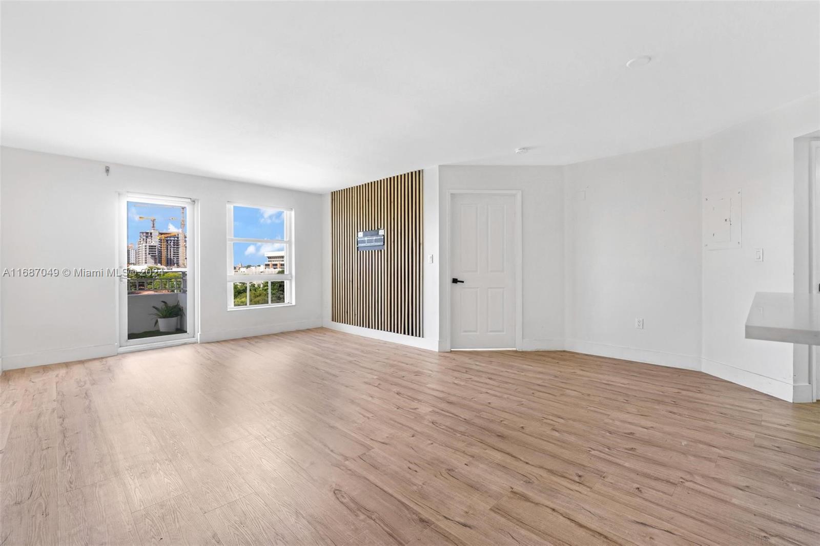 2351 Douglas Road, Unit 504 Miami, FL 33145 - Photo 10 of 41 a view of an empty room with wooden floor and a window