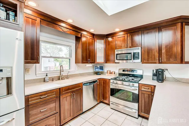 a kitchen with a stove a sink and a microwave