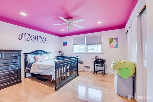 a spacious bedroom with a bed and a chandelier