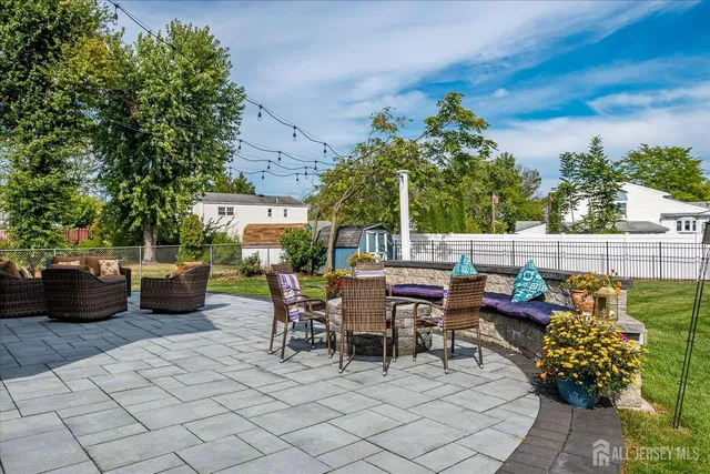 a view of a patio with couches potted plants and a table and chair