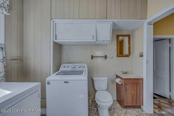 a kitchen with refrigerator and cabinets