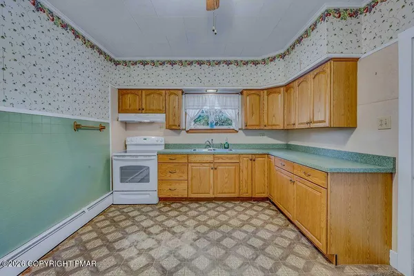 a kitchen with granite countertop a sink and a stove top oven