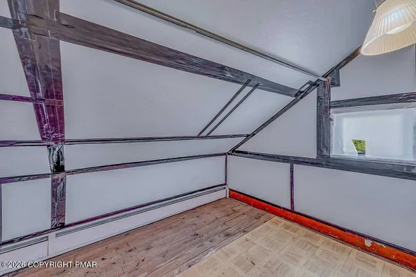 a view of a room with wooden floor