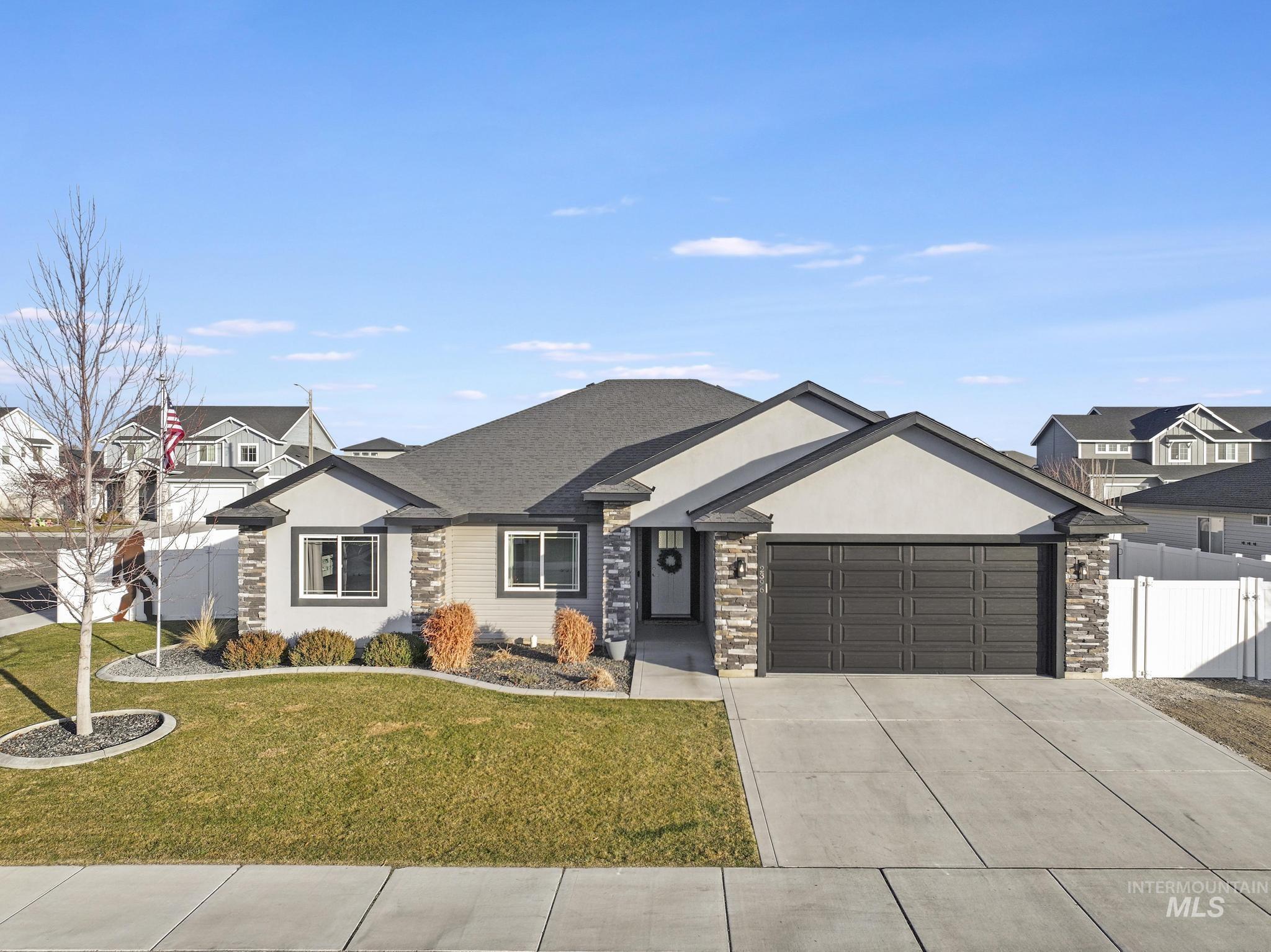 2396 Village Street Twin Falls, ID 83301 - Photo 1 of 44 View of front of home featuring driveway, a garage, stucco siding, and stone siding