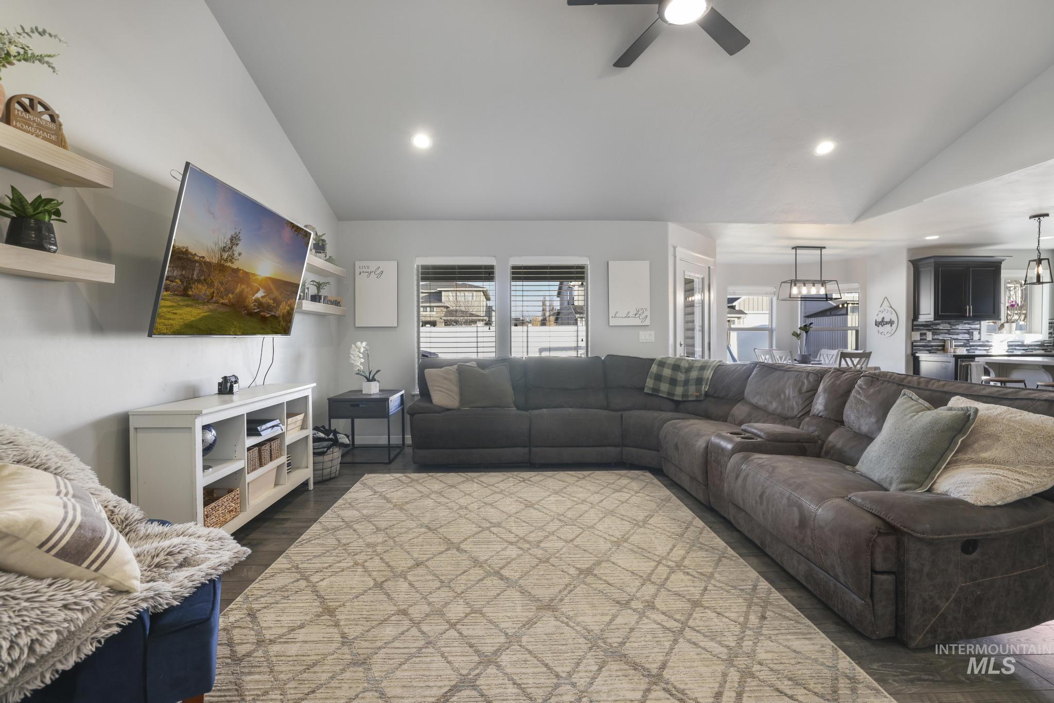 2396 Village Street Twin Falls, ID 83301 - Photo 12 of 44 Living area featuring vaulted ceiling, recessed lighting, dark wood-type flooring, and a ceiling fan