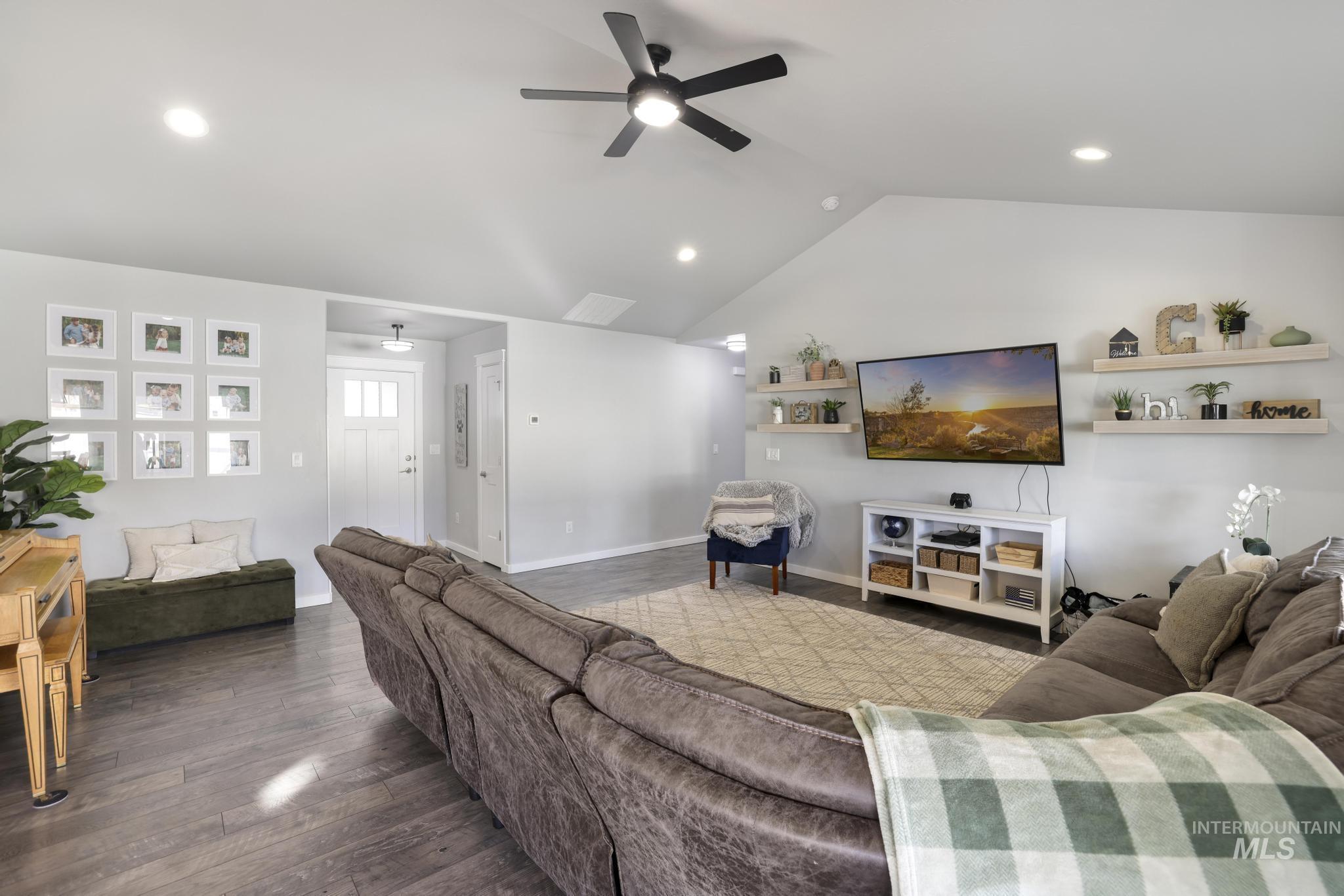 2396 Village Street Twin Falls, ID 83301 - Photo 14 of 44 Living room featuring a ceiling fan, dark wood-style floors, vaulted ceiling, and recessed lighting