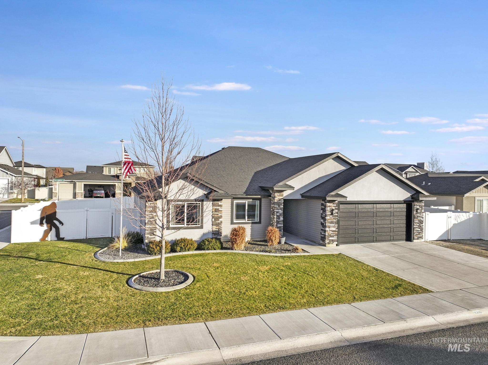 2396 Village Street Twin Falls, ID 83301 - Photo 2 of 44 View of front of property with driveway, a garage, a shingled roof, and stone siding