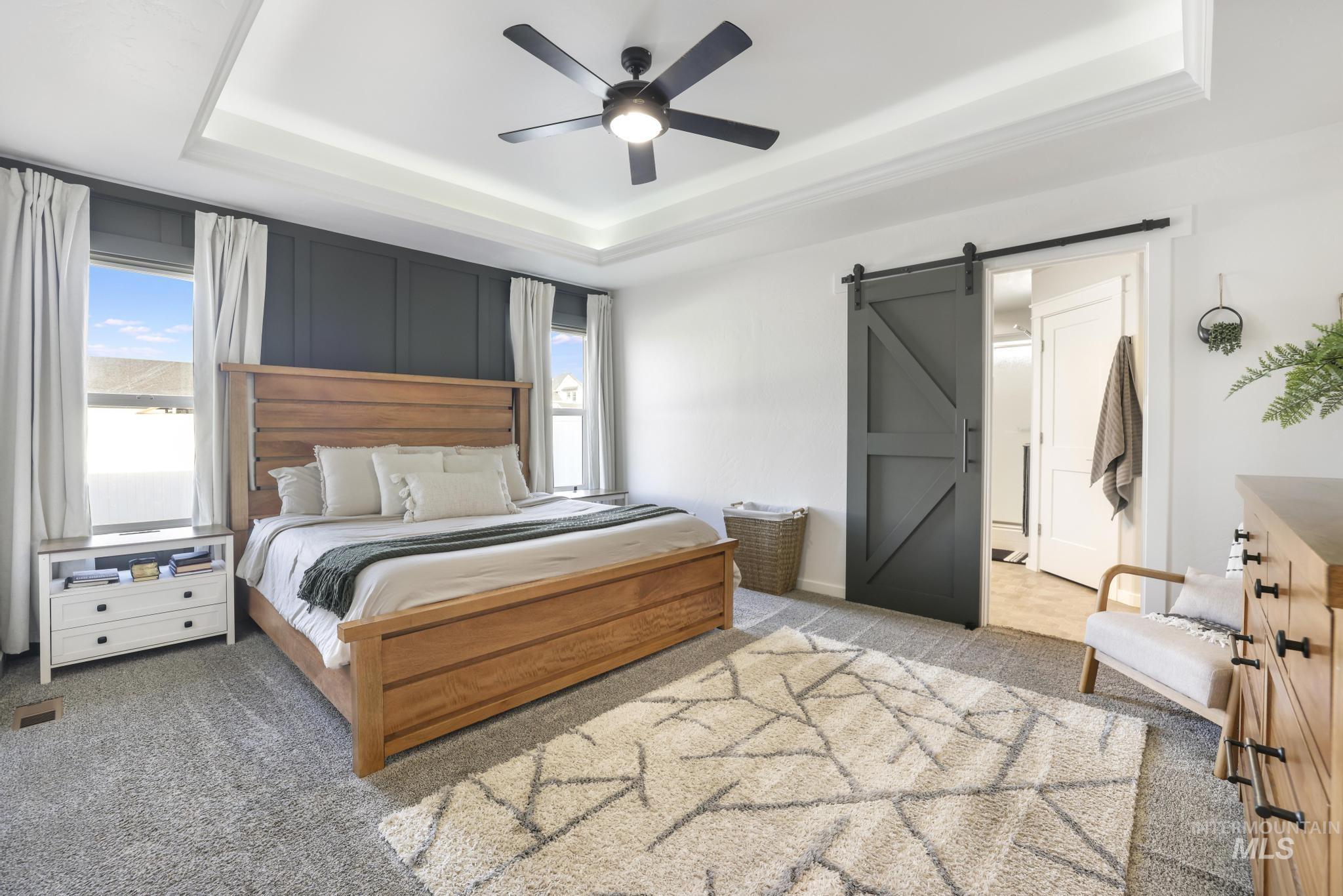 2396 Village Street Twin Falls, ID 83301 - Photo 25 of 44 Bedroom with light carpet, a barn door, and multiple windows