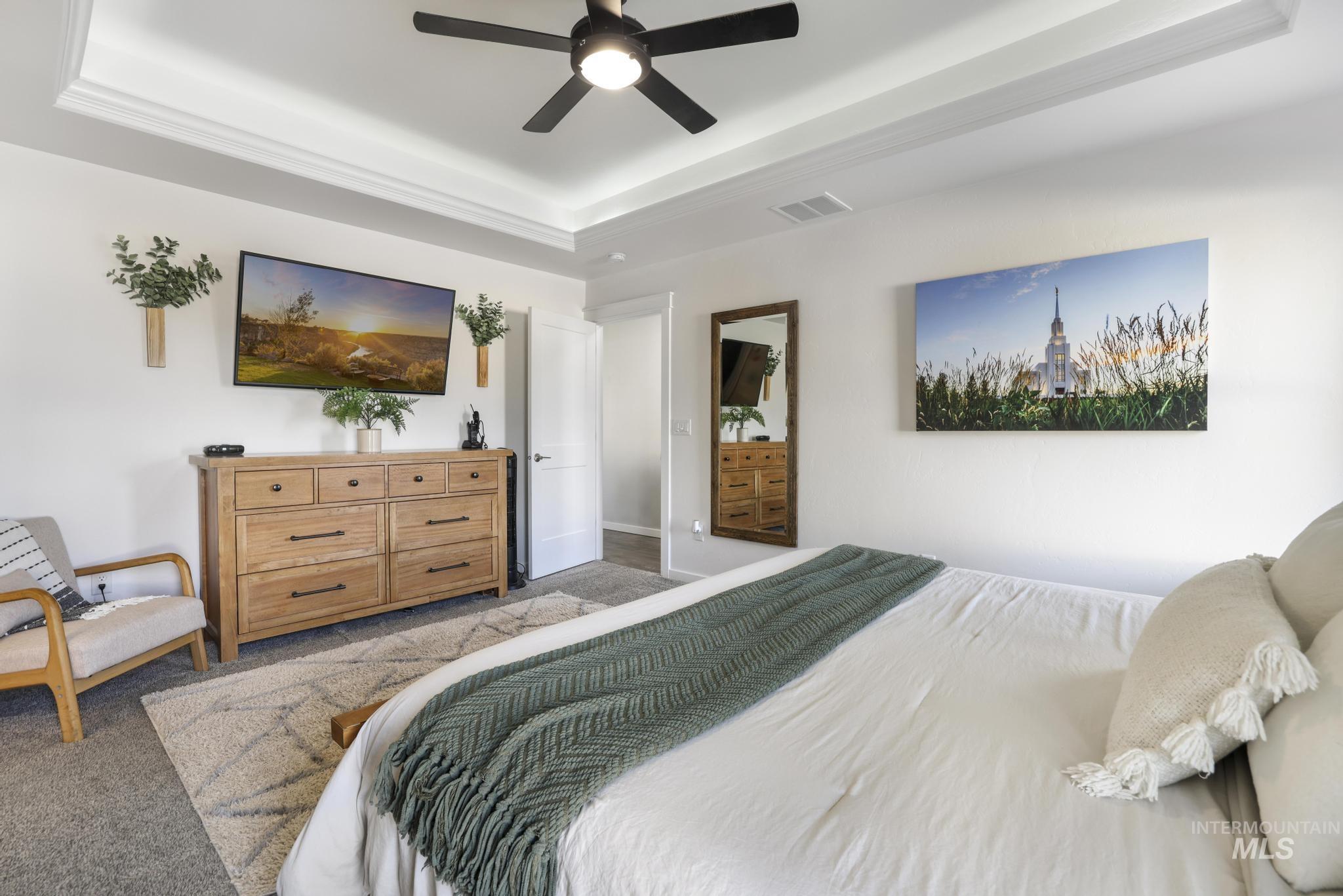2396 Village Street Twin Falls, ID 83301 - Photo 27 of 44 Carpeted bedroom featuring a raised ceiling and a ceiling fan