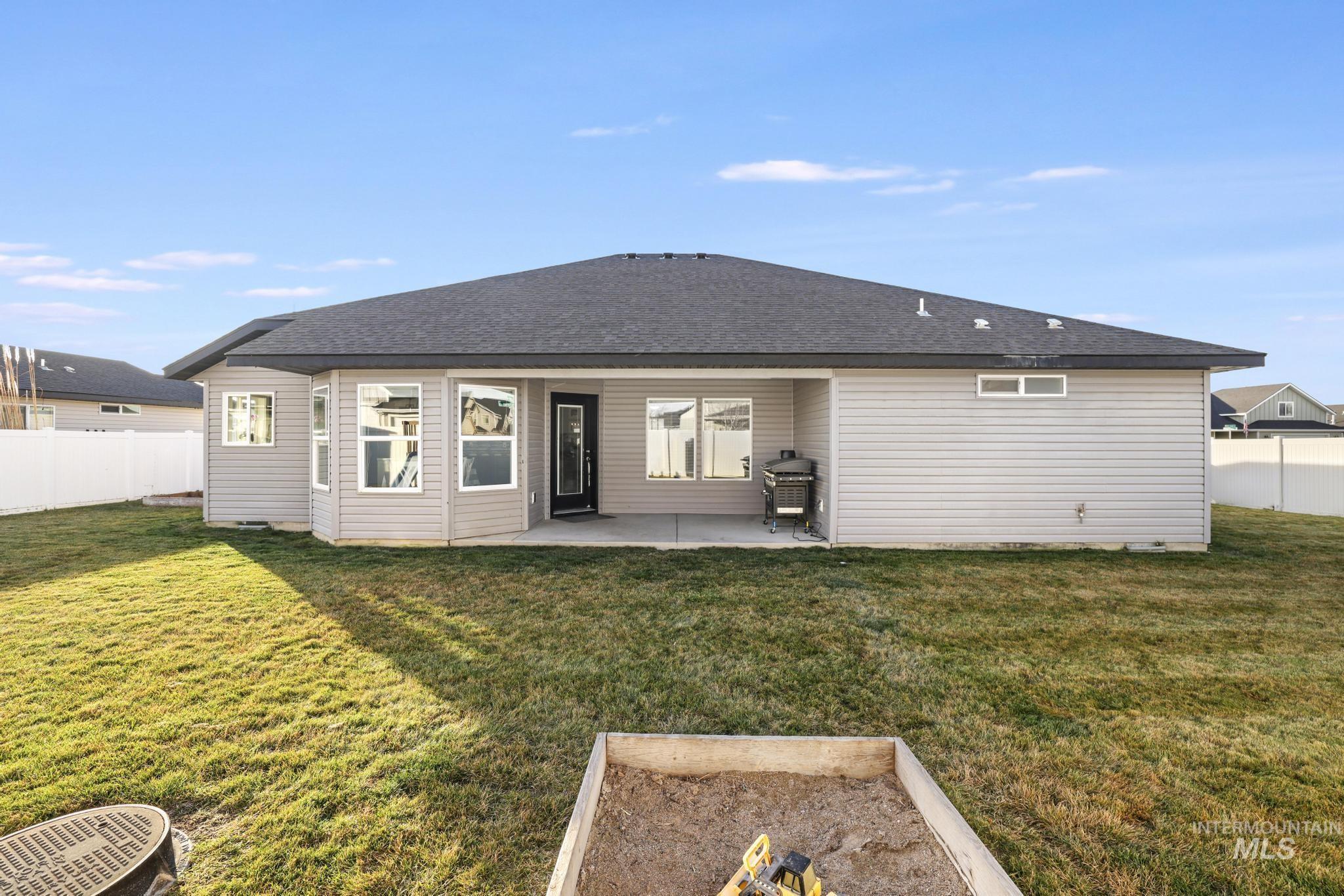 2396 Village Street Twin Falls, ID 83301 - Photo 36 of 44 Rear view of property with a fenced backyard, a patio area, roof with shingles, and a vegetable garden