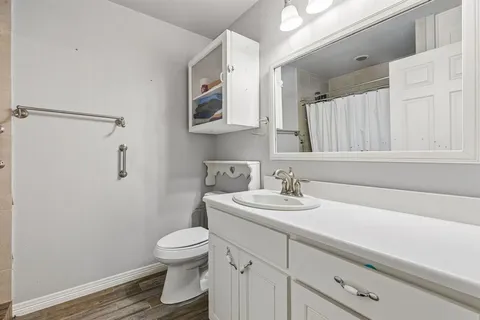 a bathroom with a toilet a sink and mirror