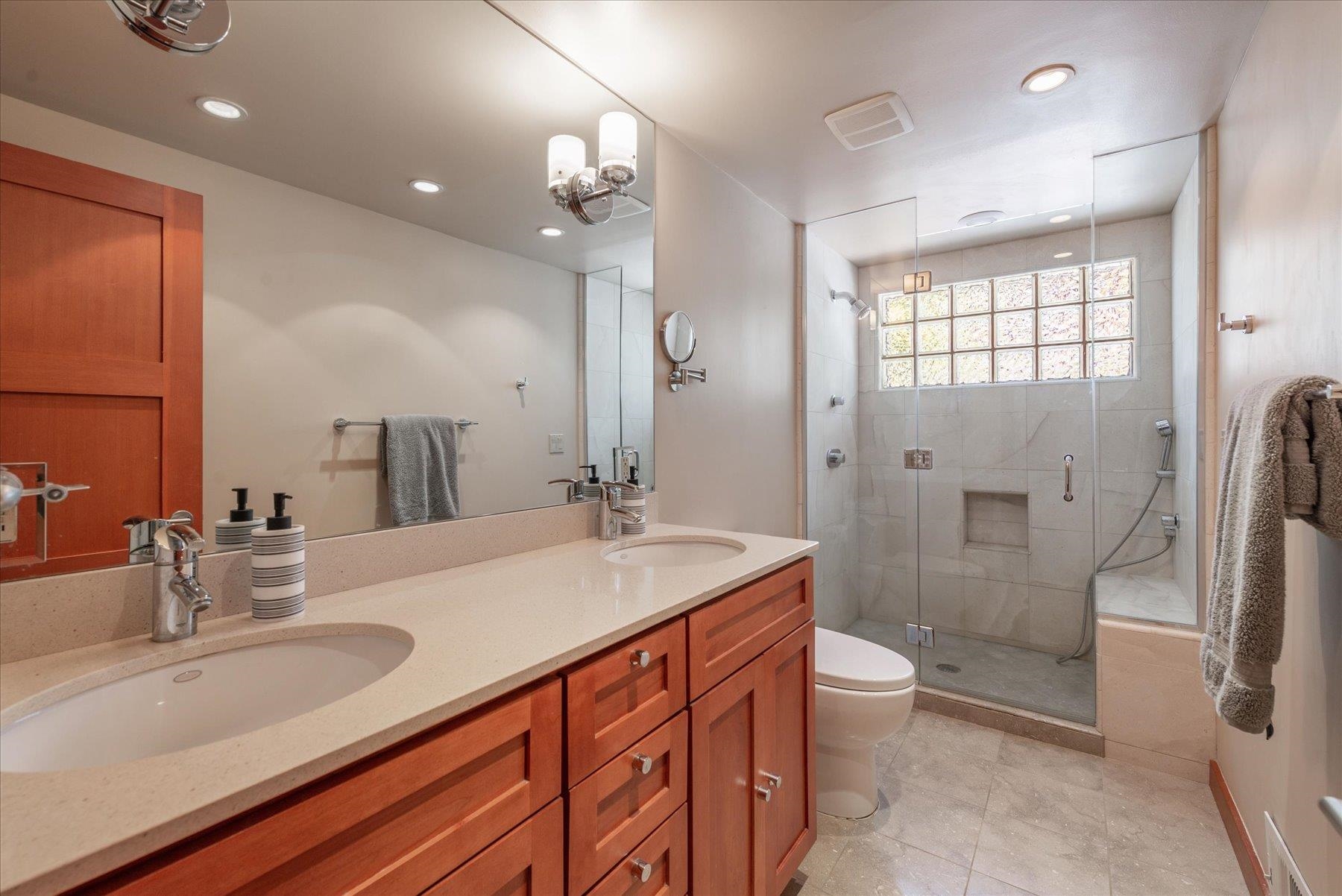 12676 Pinnacle Loop Truckee, CA 96161 - Photo 14 of 19 a spacious bathroom with a double vanity sink toilet mirror and shower
