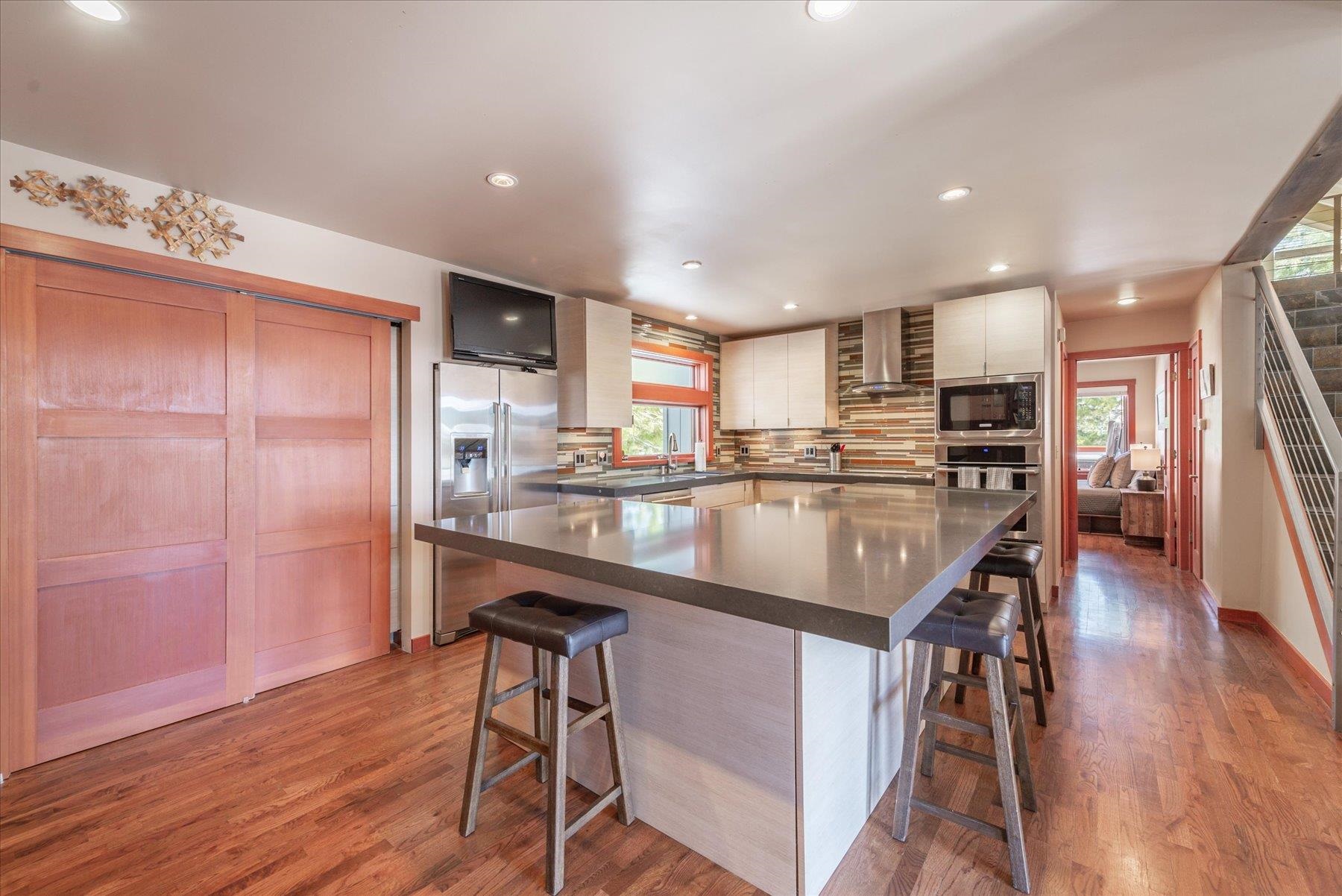 12676 Pinnacle Loop Truckee, CA 96161 - Photo 9 of 19 a kitchen with stainless steel appliances granite countertop a table chairs refrigerator and sink