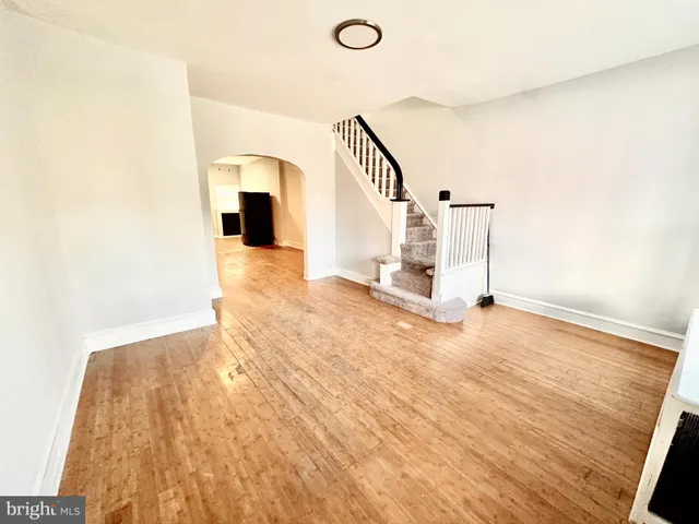 a view of a room with wooden floor and stairs