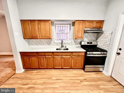 a kitchen with stainless steel appliances granite countertop a stove sink and cabinets