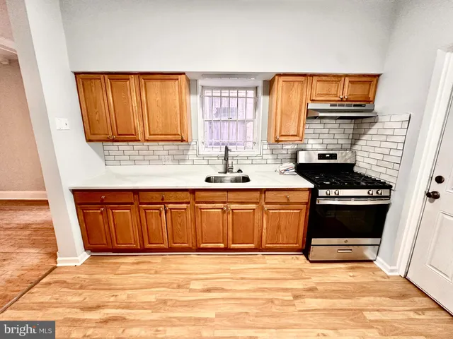 a kitchen with stainless steel appliances granite countertop a stove sink and cabinets