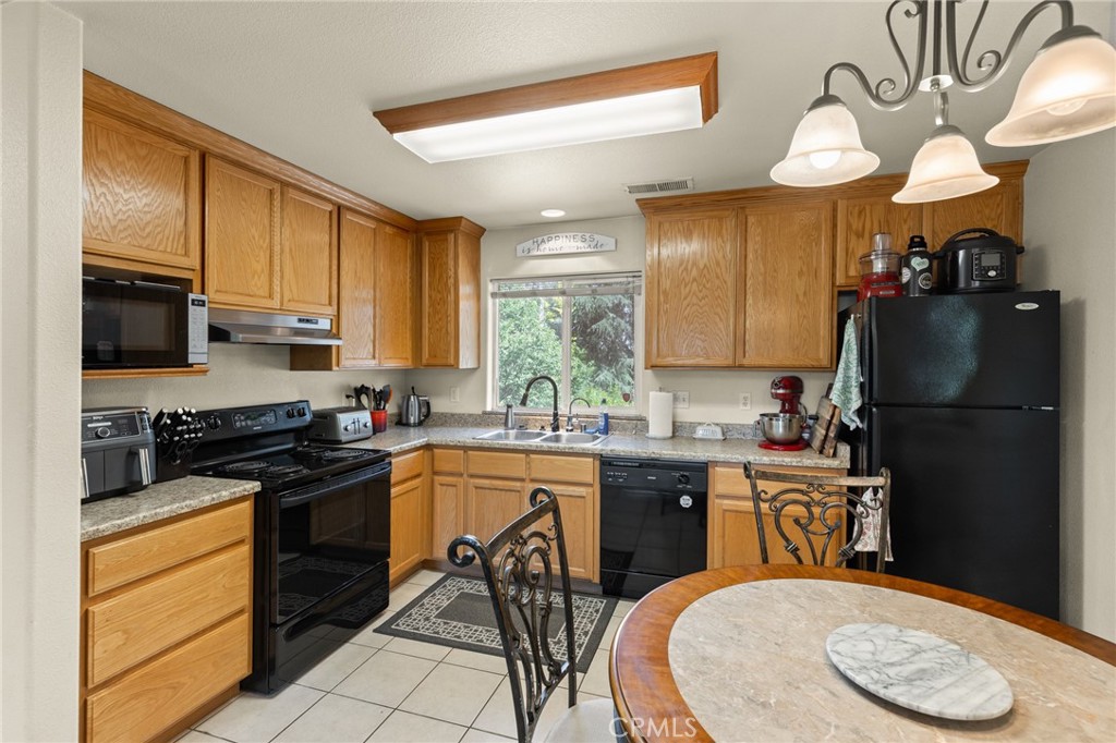 38 Kobe Loop Chico, CA 95973 - Photo 24 of 38 a kitchen with a sink a stove and chairs