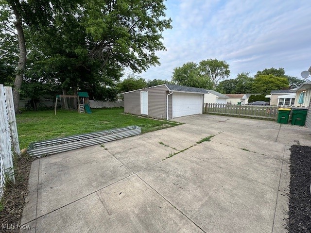 30101 Oakdale Road Willowick, OH 44095 - Photo 14 of 17 View of patio featuring a playground, an outbuilding, and a detached garage