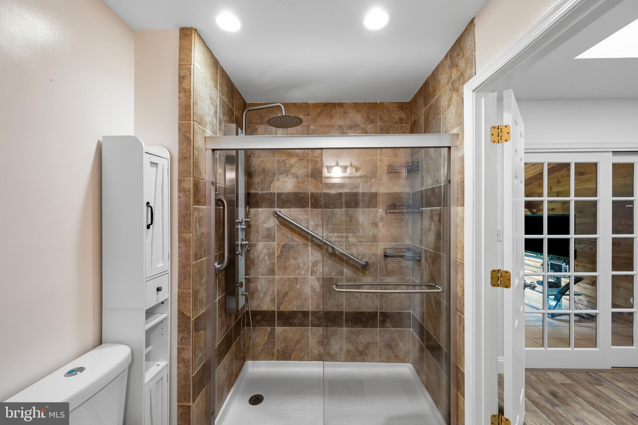 2702 Bird View Road Westminster, MD 21157 - Photo 21 of 41 a bathroom with a glass shower door and a bathtub