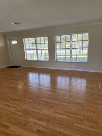 wooden floor in an empty room with a window