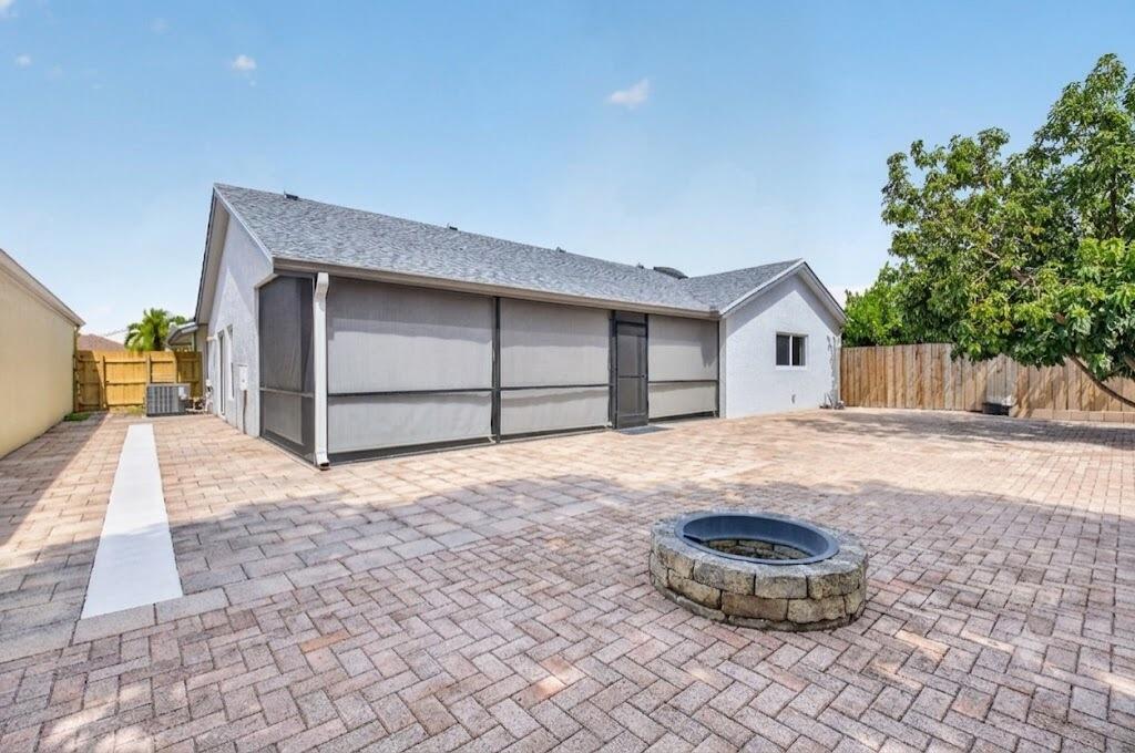 21070 Woodspring Avenue Boca Raton, FL 33428 - Photo 28 of 30 a view of a house with backyard and sitting area
