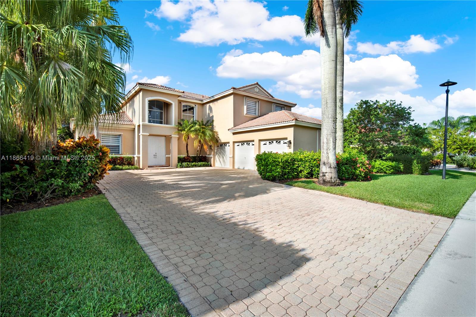 18708 Ocean Mist Drive Boca Raton, FL 33498 - Photo 2 of 58 a front view of a house with a yard