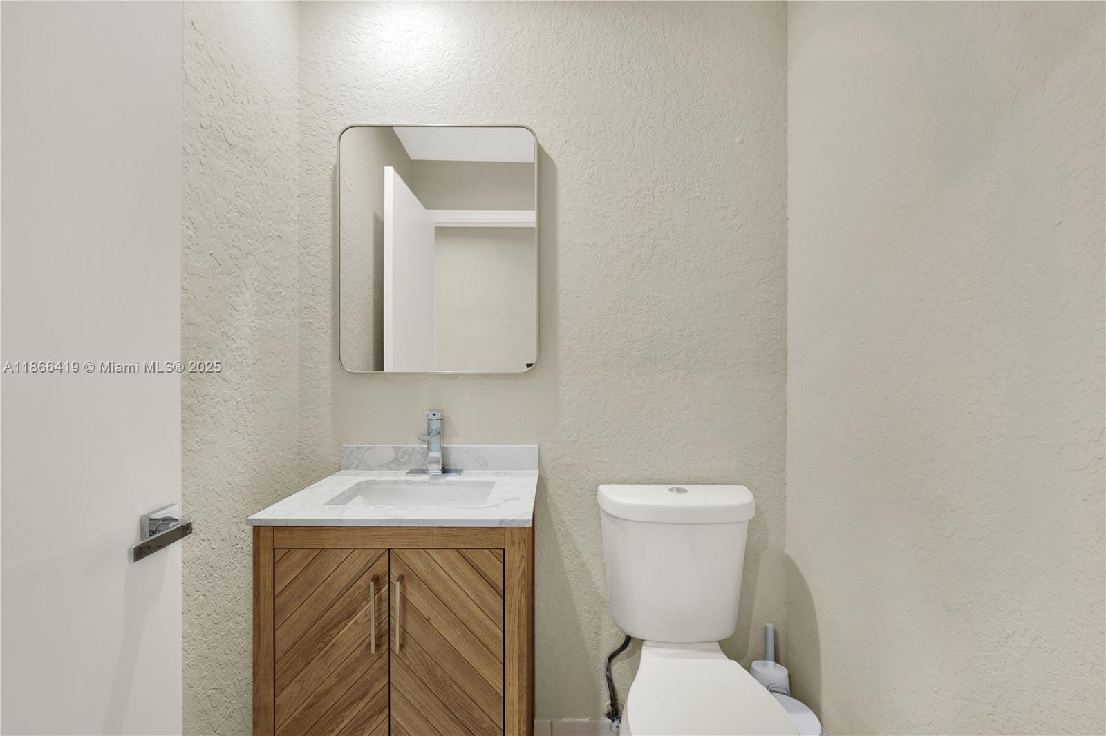 18708 Ocean Mist Drive Boca Raton, FL 33498 - Photo 23 of 58 a bathroom with a toilet sink and mirror