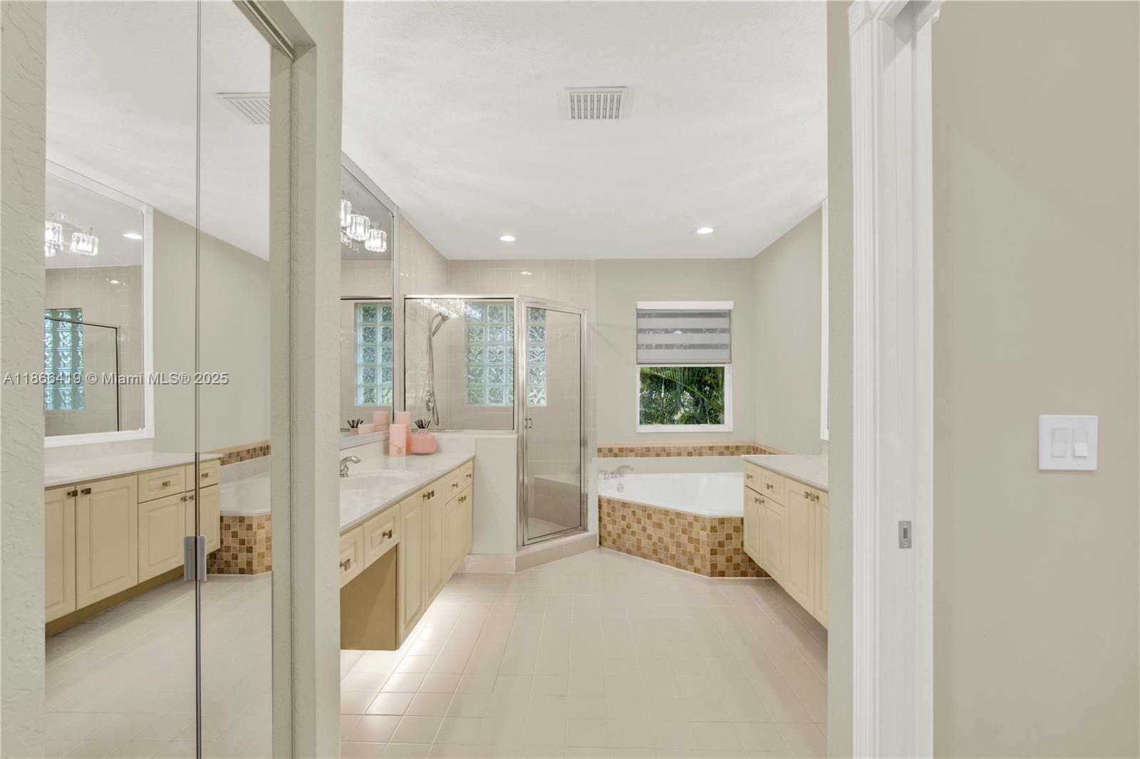 18708 Ocean Mist Drive Boca Raton, FL 33498 - Photo 28 of 58 a large white room with a large mirror vanity and a shower