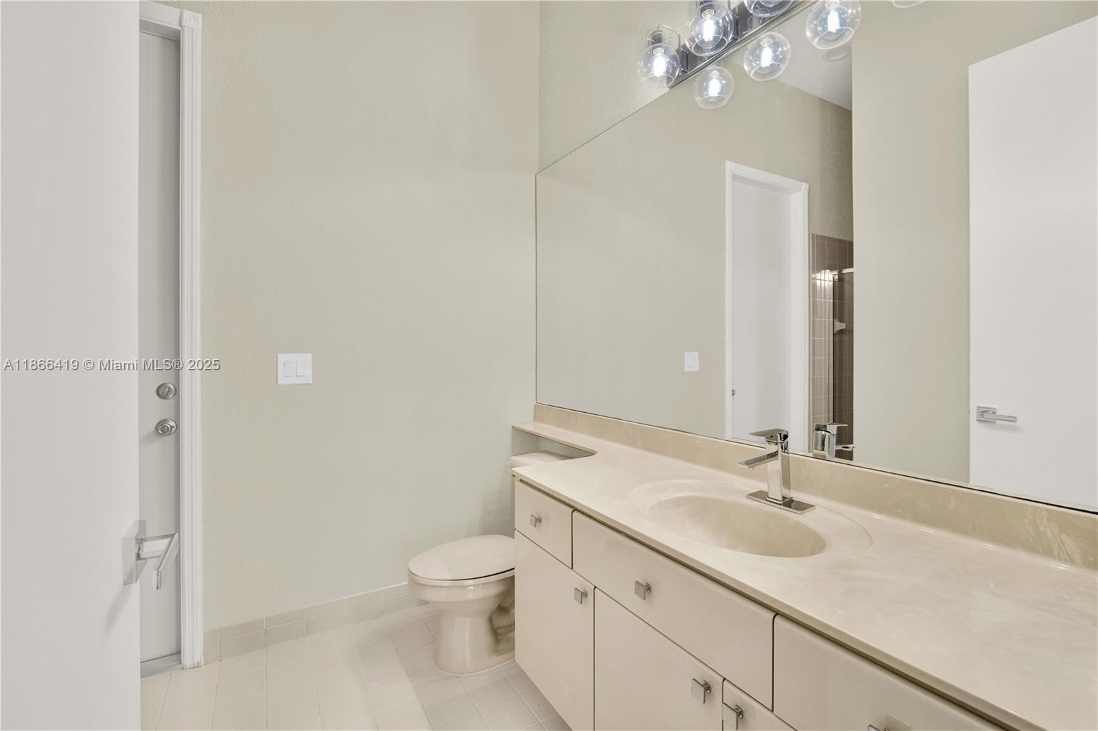 18708 Ocean Mist Drive Boca Raton, FL 33498 - Photo 32 of 58 a bathroom with a granite countertop sink a toilet and a mirror