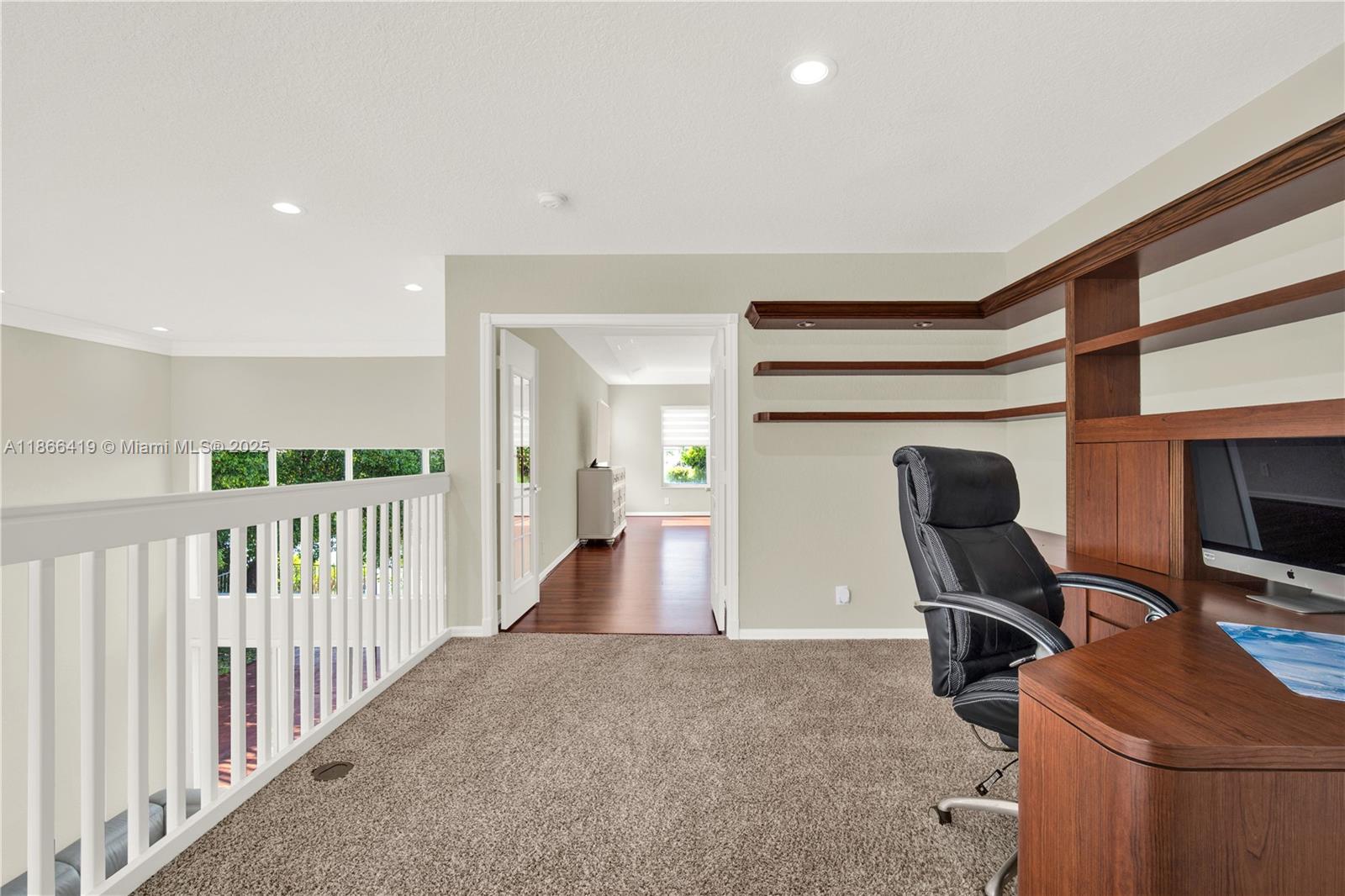 18708 Ocean Mist Drive Boca Raton, FL 33498 - Photo 37 of 58 a view of a hallway with workspace and furniture