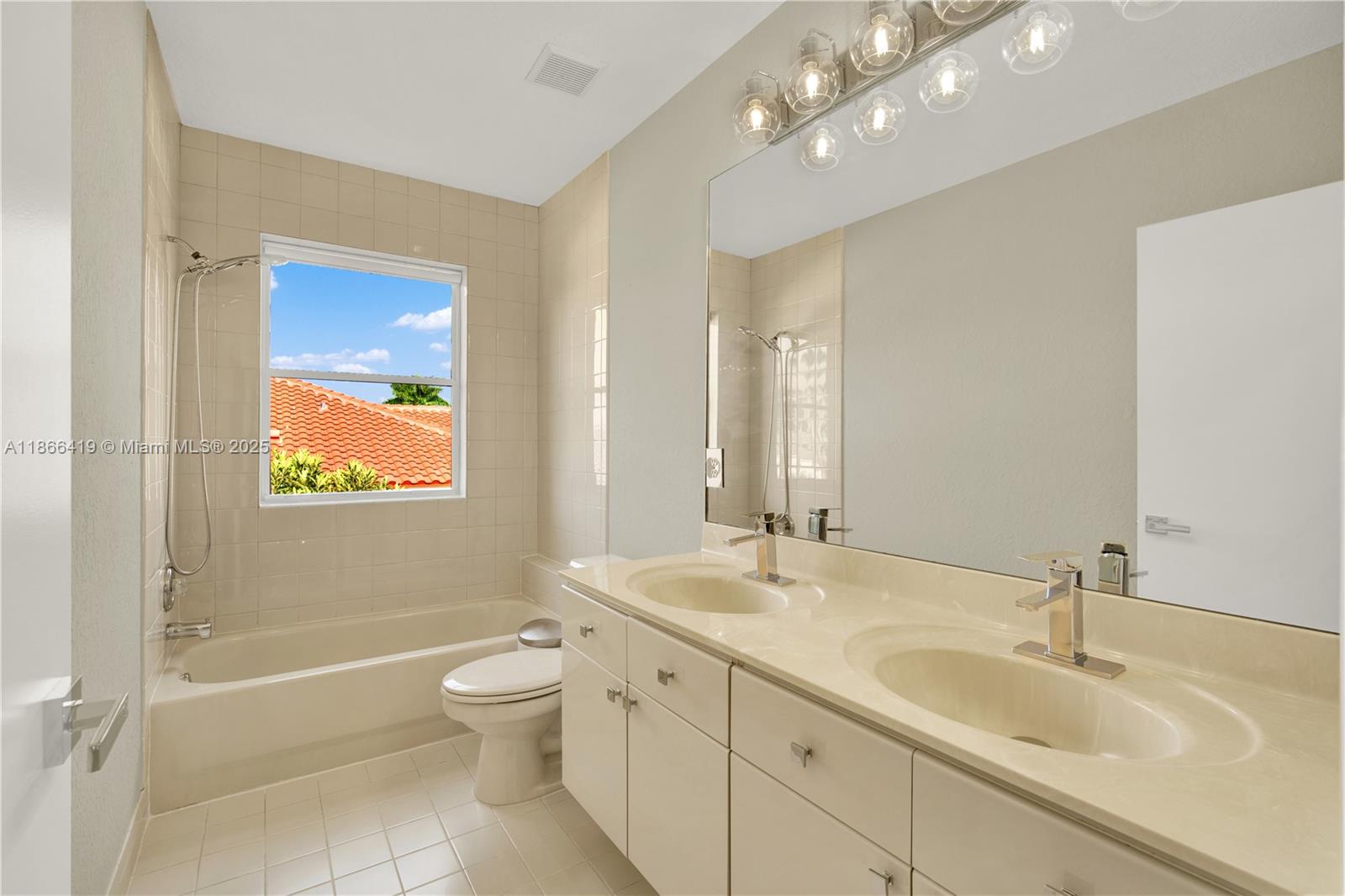 18708 Ocean Mist Drive Boca Raton, FL 33498 - Photo 38 of 58 a bathroom with a granite countertop sink a toilet a mirror and shower