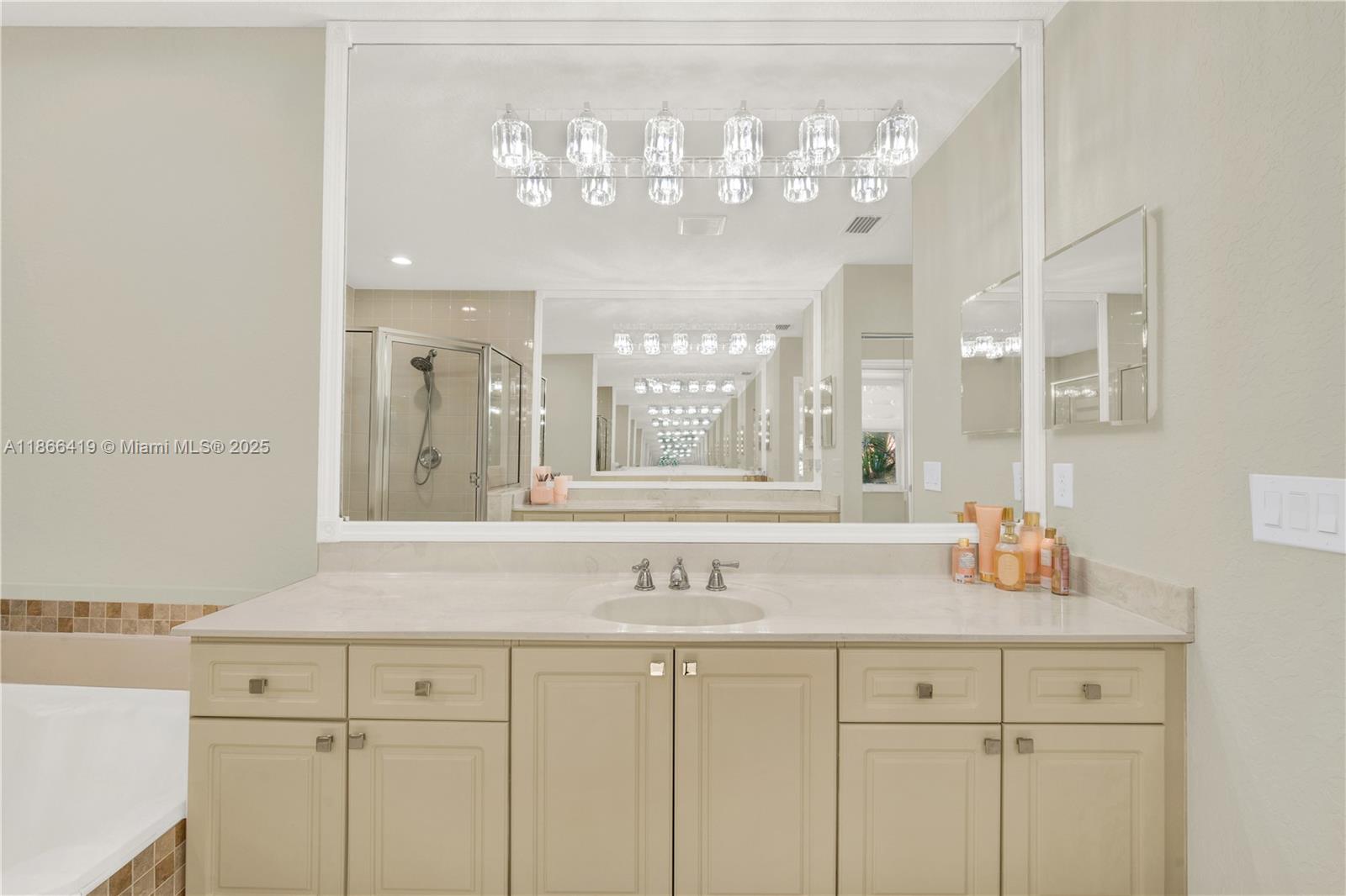 18708 Ocean Mist Drive Boca Raton, FL 33498 - Photo 39 of 58 a bathroom with a sink and a mirror