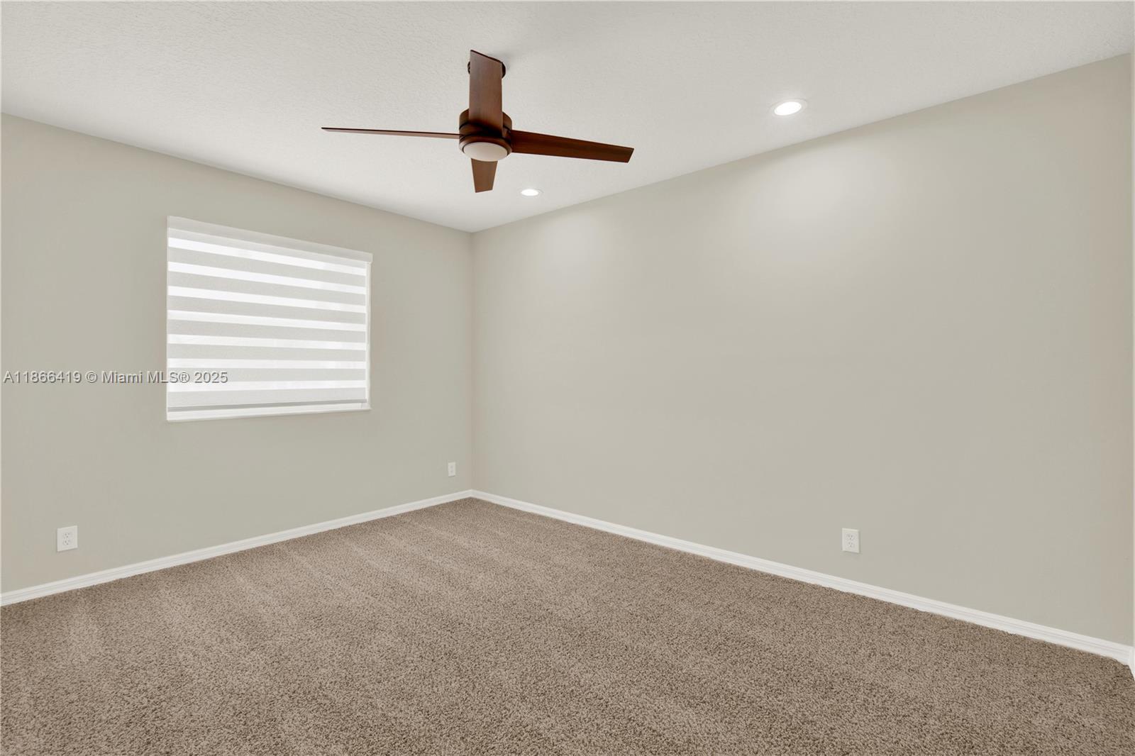 18708 Ocean Mist Drive Boca Raton, FL 33498 - Photo 40 of 58 an empty room with a window and a ceiling fan
