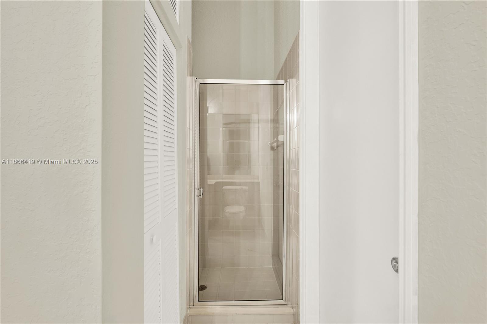 18708 Ocean Mist Drive Boca Raton, FL 33498 - Photo 42 of 58 a bathroom with a glass shower door