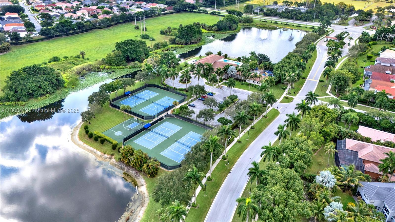 18708 Ocean Mist Drive Boca Raton, FL 33498 - Photo 46 of 58 an aerial view of a house with a garden and lake view