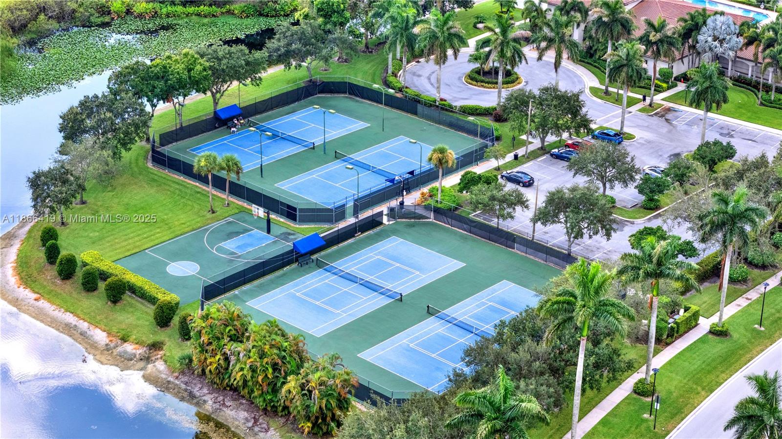 18708 Ocean Mist Drive Boca Raton, FL 33498 - Photo 47 of 58 an aerial view of a tennis ground and a houses