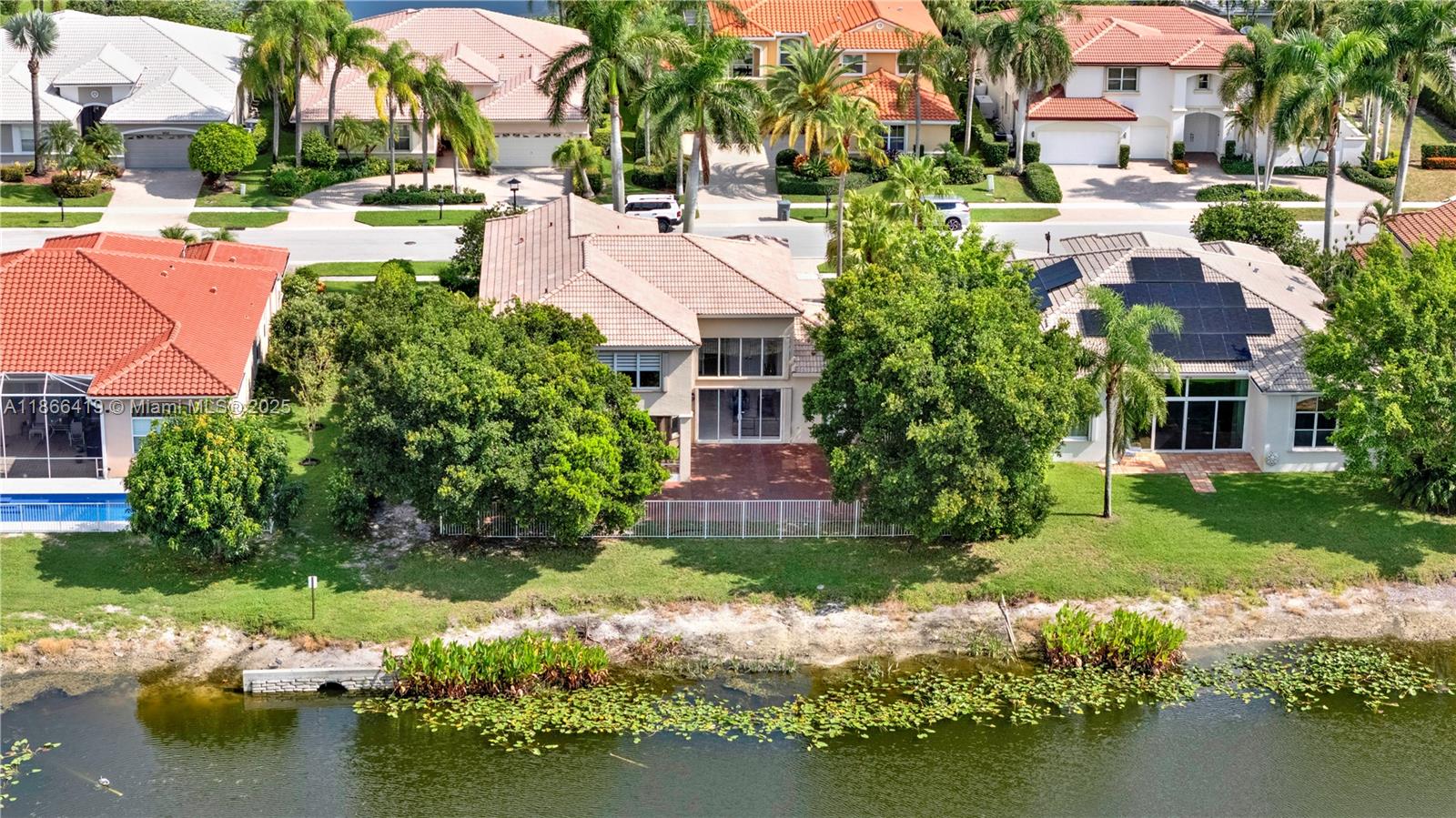18708 Ocean Mist Drive Boca Raton, FL 33498 - Photo 55 of 58 a view of backyard of house with yard and lake view