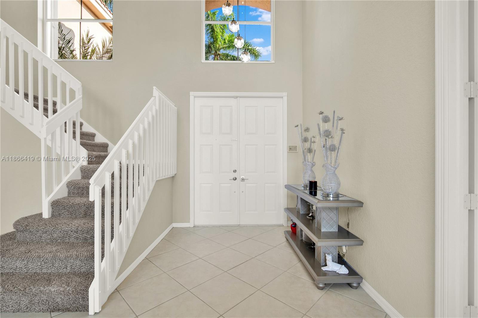 18708 Ocean Mist Drive Boca Raton, FL 33498 - Photo 7 of 58 a view of staircase with white walls and a window