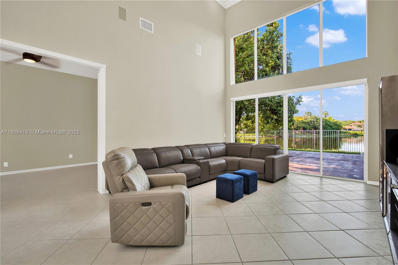 18708 Ocean Mist Drive Boca Raton, FL 33498 - Photo 8 of 58 a living room with furniture and large windows