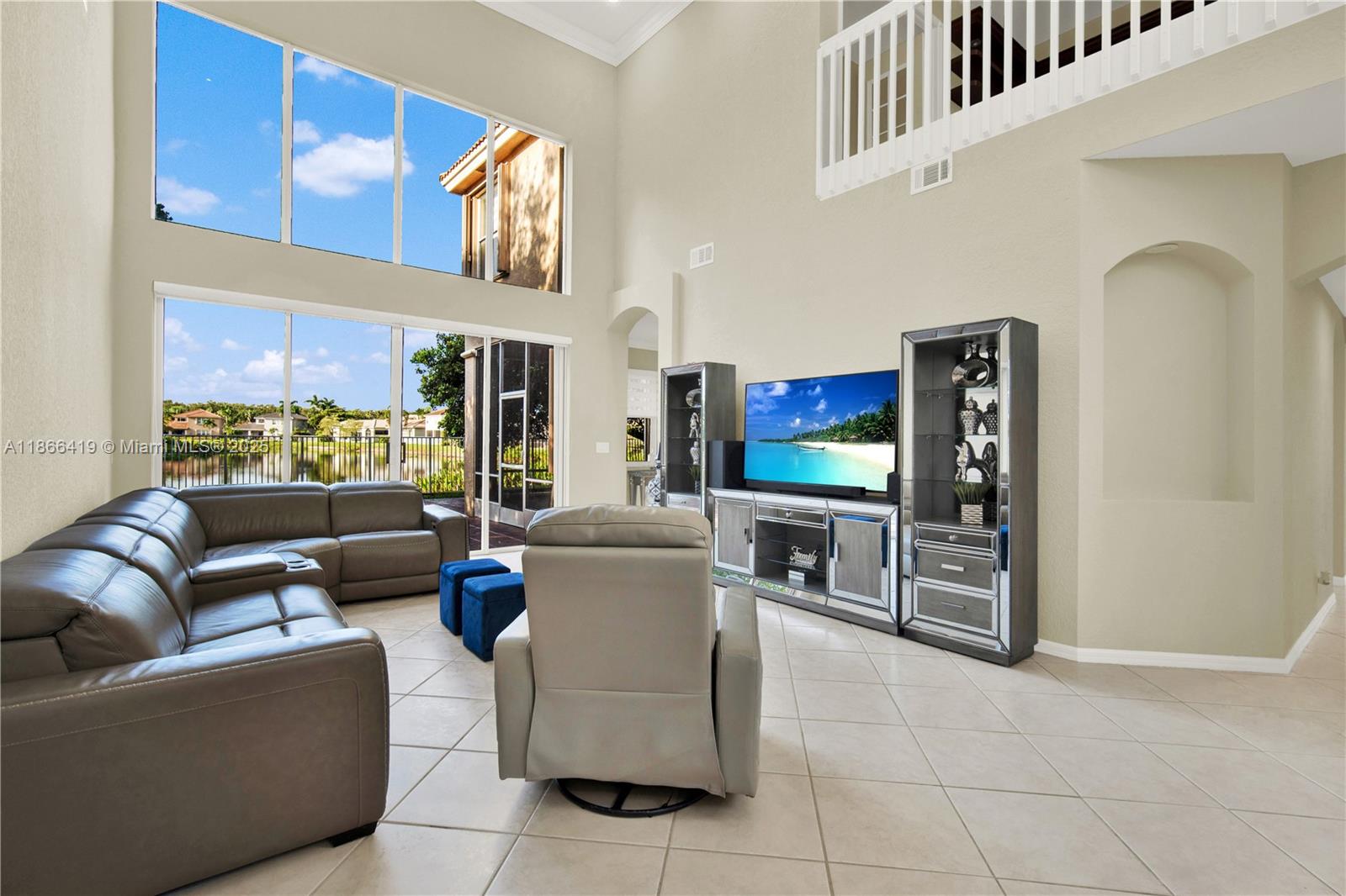 18708 Ocean Mist Drive Boca Raton, FL 33498 - Photo 9 of 58 a living room with furniture and a flat screen tv