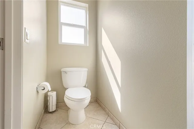 a bathroom with a toilet and a window