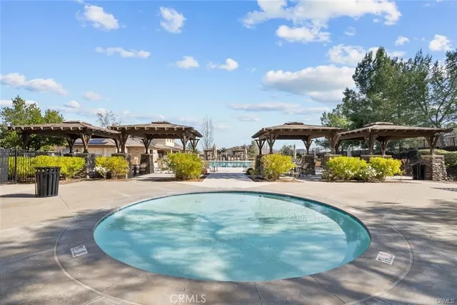 a view of a swimming pool with an outdoor seating