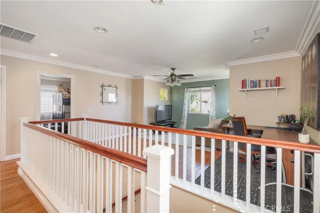 a view of a hallway with windows and stairs